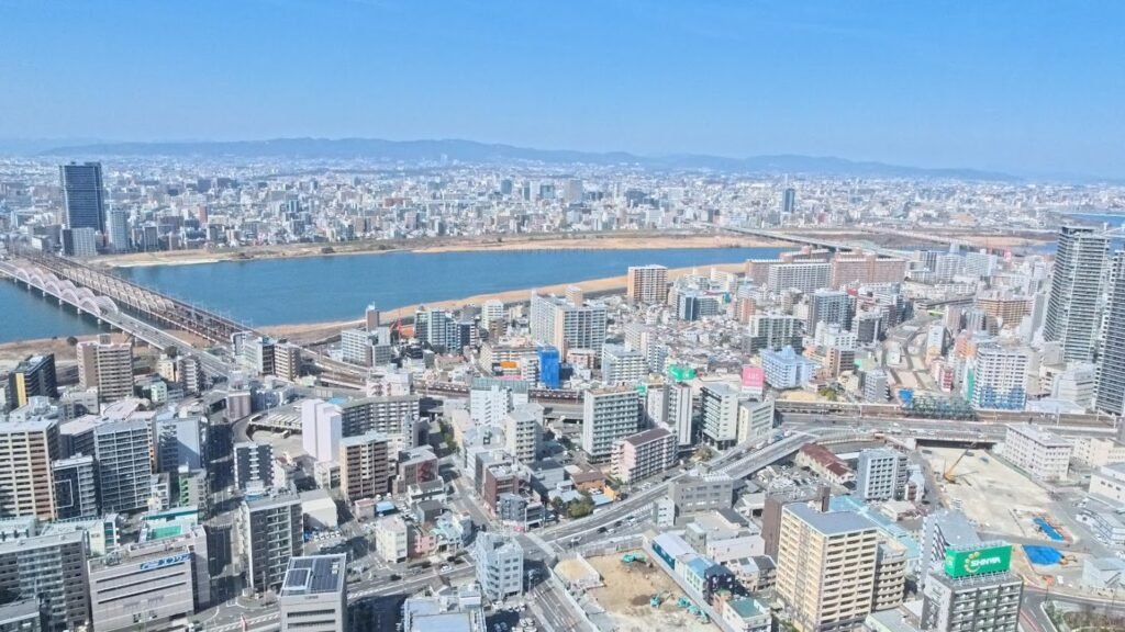 Panoramic city view of Osaka seen from the Umeda Sky Building observatory.