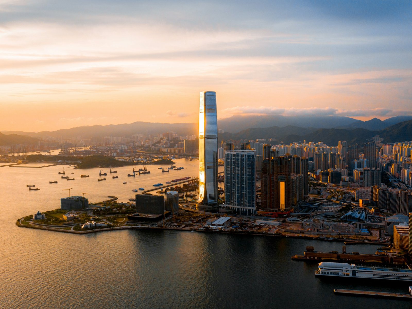 Hong Kong skyline across Victoria Harbour near sunset